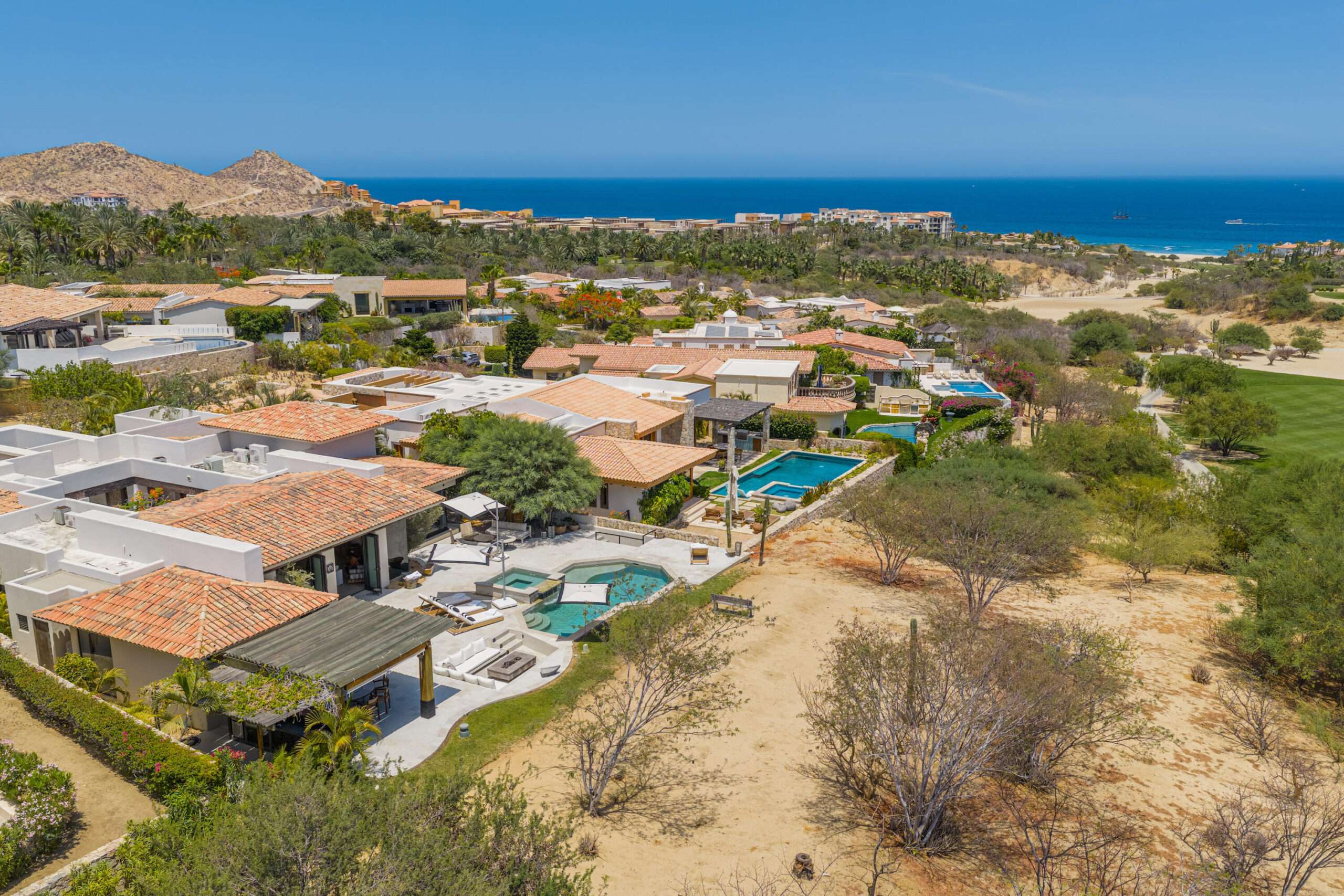 Cabo del Sol Brisas Discover Naah Payil, an exceptional estate where the warmth of a Contemporary Mexican Hacienda blends seamlessly with the relaxed sophistication of coastal living. Located within one of Los Cabos' most exclusive and secure communities, this architectural masterpiece was custom-designed by MCA, led by renowned architect Antonio Carrera. Thoughtfully enhanced in 2015 and again in 2025, the residence beautifully balances timeless character with today's highest standards of comfort and design. At the heart of the home, a central courtyard anchored by a signature tree creates a tranquil gathering space filled with natural light. The home's thoughtful design embraces effortless indoor-outdoor living. Open the grand living room doors, and refreshing ocean breezes naturally flow throughout the residence, creating a comfortable and inviting atmosphere for sale